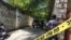 Journalists stand by a yellow police cordon near the residence of Haiti's President Jovenel Moise after he was shot dead by unidentified attackers, in Port-au-Prince, Haiti, July 7, 2021.