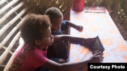 Students in Vanuatu use the SolarSPELL offline library (Photograph courtesy of Dr. Laura Hosman)