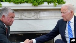President Joe Biden, right, shakes hands with Jordan's King Abdullah II in the Oval Office of the White House in Washington, July 19, 2021.