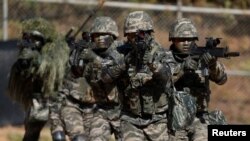 FILE - South Korean marines are pictured in action during a regular drill on Yeonpyeong Island, Nov. 1, 2018. 