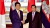 Cambodian Prime Minister Hun Sen, right, poses with his Japanese counterpart Shinzo Abe prior to their meeting at the state guesthouse in Tokyo Monday, Aug. 7, 2017. Hun Sen is on a four-day official visit to Japan. (Toshifumi Kitamura/Pool Photo via AP)