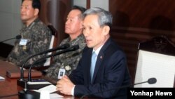 A child brings a candle to a Jewish cemetery at the former Terezin Nazi concentration camp in Terezin (Theresiendstadt ) during the ceremony to mark the 70th anniversary of the liberation of the former Nazi concentration camp Auschwitz-Birkenau in Oswiecim, Poland.