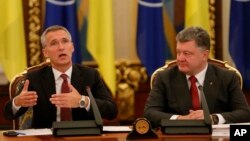 Ukrainian President Petro Poroshenko (R) looks at NATO Secretary-General Jens Stoltenberg as he speaks during a meeting of the National Security and Defense Council of Ukraine in Kyiv, Ukraine, Sept. 22, 2015.