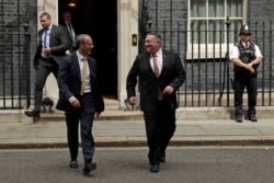 British Foreign Secretary Dominic Raab, left, walks with U.S. Secretary of State Mike Pompeo outside of 10 Downing Street, in London, July 21, 2020.