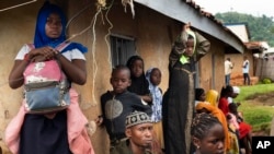 FILE - Residents wait to receive the Ebola vaccine in Beni, Congo DRC on July 13, 2019. Documents obtained by The Associated Press show the World Health Organization paid $250 each to at least 104 women in Congo who say they were sexually abused or exploited by Ebola responders.