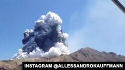 This handout photo taken on July 23, 2019 and released to AFP courtesy of Chris Firkin on December 9, 2019 shows the volcano on New Zealand's White Island spewing steam and ash.