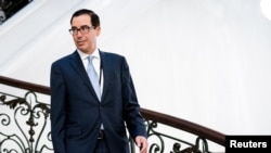 FILE - U.S. Treasury Secretary Steven Mnuchin walks to a working breakfast at the G7 Summit in Biarritz, France, Aug. 25, 2019.