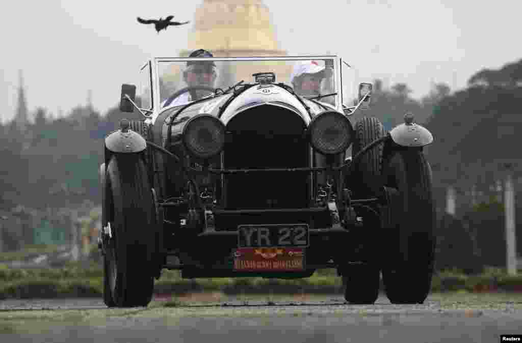 A 1928 Bentley classic car stops in front of Shwedagon pagoda during the start of "The Burma Road Classic" motoring rally in Rangoon, Burma.