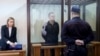 Journalist Andrzej Poczobut, center, stands in a defendants' cage during a court session in Grodno, Belarus, Jan. 16, 2023. 