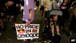 A man carries a placard at an Invasion Day rally in Sydney, Jan. 26, 2023. 
