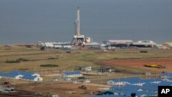 The drilling rig of the Kingfisher oil field, operated by China National Offshore Oil Corporation (CNOOC), is seen on the shores of Lake Albert in the Kikuube district of western Uganda Tuesday, Jan. 24, 2023. (AP Photo/Hajarah Nalwadda)