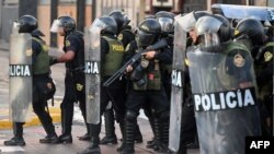 Riot police takes position during a protest against the government of Dina Boluarte asking for her resignation and the closure of Congress, in Lima on Jan. 24, 2023.