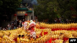 A 238m-long dragon dance is performed in front of the A-Ma Temple during celebrations on the first day of the Chinese lunar new year in Macau, China, Jan. 22, 2023.