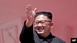 FILE - In this Sept. 9, 2018, photo, North Korean leader Kim Jong Un waves after a parade for the 70th anniversary of North Korea's founding day in Pyongyang, North Korea. 