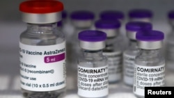 Vials of the AstraZeneca and Pfizer-BioNTech Comirnaty coronavirus disease (COVID-19) vaccines are pictured in a General practitioners practice in Berlin, Germany, April 10, 2021. 