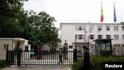 A man walks past a paramilitary police officer keeping watch outside the Myanmar embassy in Beijing, China August 8, 2022.