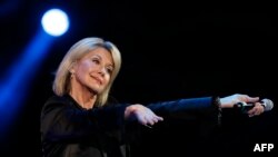 FILE - Singer Olivia Newton-John performs at the 58th Vina del Mar International Song Festival in Vina del Mar, Chile, Feb. 23, 2017.