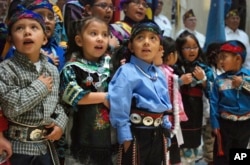Children from Zuni Pueblo lead the U.S. pledge of allegiance in the Zuni language in the State Capitol in Santa Fe, N.M., on Friday, Feb. 2, 2018.
