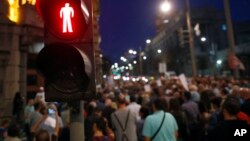 FILE - Journalists gather during a protest organized by the Group for Media Freedom in front of the government headquarters in Belgrade, Serbia, Oct. 16, 2019. The Independent Association of Journalists of Serbia or NUNS has documented 36 attacks on journalists so far this year. 