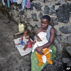 A woman looks after her two babies after being abandoned by her husband for being raped, in Goma (File)