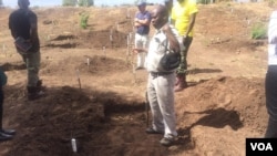 Some of the people involved in the demining exercise showing part of the area that has been cleared of landmines.