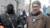 In this photo taken on April 13, 2014, American reporter Simon Ostrovsky, right, stands with a pro-Russian gunman near a police station in the eastern Ukrainian town of Slovyansk. 