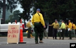 Firefighters gather in Cascade Locks, Ore., Sept. 6, 2017, near where the Eagle Creek wildfire continues to burn. Firefighting crews are in the town in anticipation of west winds possibly pushing the fire into town.