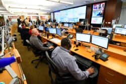 FILE - Personnel at the The Centers for Disease Control and Prevention (CDC) work the Emergency Operations Center in response to the coronavirus, among other threats, Feb. 13, 2020, in Atlanta, Georgia.