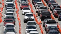 Lines of cars wait at a coronavirus testing site outside of Hard Rock Stadium, in Miami Gardens, Fla., June 26, 2020.