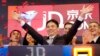 FILE - Liu Qiangdong, also known as Richard Liu, CEO of JD.com, raises his arms to celebrate the IPO for his company at the Nasdaq MarketSite, in New York on May 22, 2014.