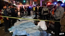 The bodies of victims killed in a Halloween crush are covered with sheets in the neighborhood of Itaewon in Seoul Oct. 30, 2022.