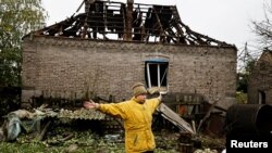 A woman reacts as she talks to journalists following a Russian missile strike, as Russia's attack on Ukraine continues, in Kramatorsk, Donetsk region, Ukraine, Oct. 4, 2022. 