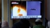  A TV screen shows file images of a North Korean missile launch during a news program at the Seoul Railway Station in Seoul, South Korea, Oct. 13, 2022. 