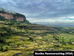 Waterfalls plunge down the face of Guinea's Mount Gangan. It's the kind of tropical paradise that tourists would flock to, but its tourism sector has not yet been developed.