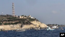 FILE - Lebanese protesters in boats demand their cash-strapped country's right to its oil and gas fields on the Mediterranean Sea, near the southern marine border town of Naqoura, Lebanon, Sept. 4, 2022.