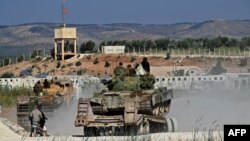 Members of the Hayat Tahrir al-Sham (HTS) jihadist group bring reinforcements on the outskirts of the Afrin region of Syria's rebel-held northern Aleppo province, Oct. 13, 2022.