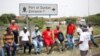 FILE - Transnet workers protest as a labour strike continues at an entrance to the harbour in Durban, South Africa, Oct. 17, 2022.