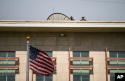 U.S. soldiers stand guard on the roof of the U.S. Embassy as they watch a protest to reject an international military force requested by the government and to demand the resignation of Prime Minister Ariel Henry, in Port-au-Prince, Haiti, Oct. 17, 2022.