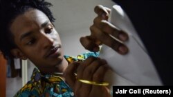 Esteban Sinisterra works on a dress on a mannequin in his studio in Cali, Colombia September 7, 2022.