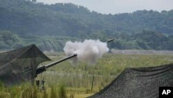 FILE - A U.S .155mm Howitzer fires a round during annual combat drills between the Philippine Marine Corps and U.S. Marine Corps in the northern Philippines, Oct. 13, 2022. Filipino and U.S. troops will kick off joint military exercises in the Philippines on Monday.