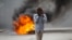 FILE - A man walks past a burning barricade during a protest over the death of journalist Romelo Vilsaint, in Port-au-Prince, Haiti, Oct. 30, 2022. As violence sweeps Haiti, the country's journalists are being targeted. 
