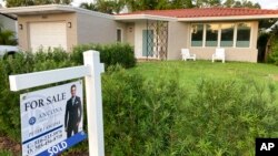 FILE - A home with a 'sold' sign is shown, May 2, 2021, in Surfside, Fla.