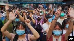 FILE - Protesters against a national security law signify their "five demands, not one less" on the anniversary of Hong Kong's handover to China, in Hong Kong, July 1, 2020. Hong Kong’s government has pulled a national security bill from the legislature’s schedule for 2022.