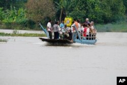 The coffin of Son Sophat, a teen victim of a boat accident, is carried in a wooden boat during a funeral procession in Koh Chamroeun village, east of Phnom Penh, Cambodia, Friday, Oct. 14, 2022. (AP Photo/Heng Sinith)