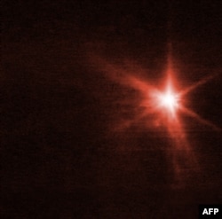 This handout picture released Sept. 29, 2022, by the European Space Agency is an image from the Webb telescope's Near-Infrared Camera showing Dimorphos, an asteroid moonlet, about four hours after NASA's Double Asteroid Redirection Test (DART) made impact.