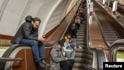 People shelter inside a subway station during a Russian missile attack in Kyiv, Ukraine, Oct. 25, 2022. 