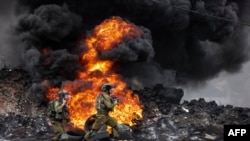 FILE - Israeli soldiers deploy amid clashes with Palestinian demonstrators following a protest against the expropriation of Palestinian land by Israel in the village of Kfar Qaddum in the occupied West Bank, near the Jewish settlement of Kedumim.