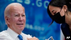 Presiden Joe Biden mendapatkan booster COVID-19 dari seorang anggota unit medis Gedung Putih dalam sebuah acara di South Court Auditorium di Gedung Putih, Washington, D.C., Selasa, 25 Oktober 2022. (AP/Evan Vucci)