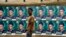FILE - A man walks past campaign posters displayed in Osogbo, Osun State in southwest Nigeria, July 15, 2022. Fact-checkers across the country say they are joining forces to counter misinformation in the runup to the general election.
