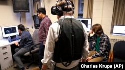 Students at Boston College in Boston, Massachusetts use one of their professors to test special technology for a video game they are developing.